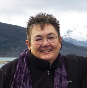 A portrait of Ellen O'Brien with a snowy mountain behind